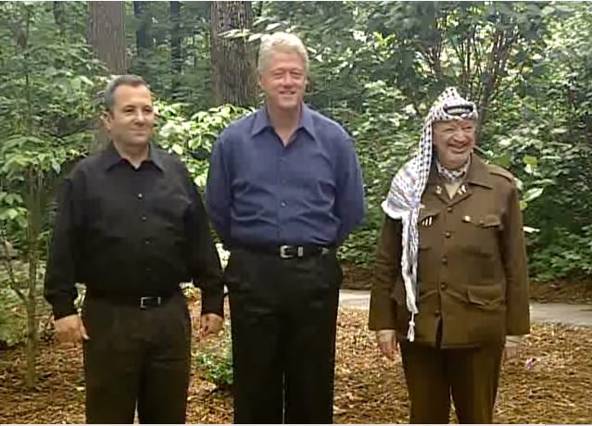 A still from a video recording of President William Jefferson Clinton, Prime Minister Ehud Barak and Chairman Yasir Arafat participating in a photo opportunity at Camp David. Public Domain